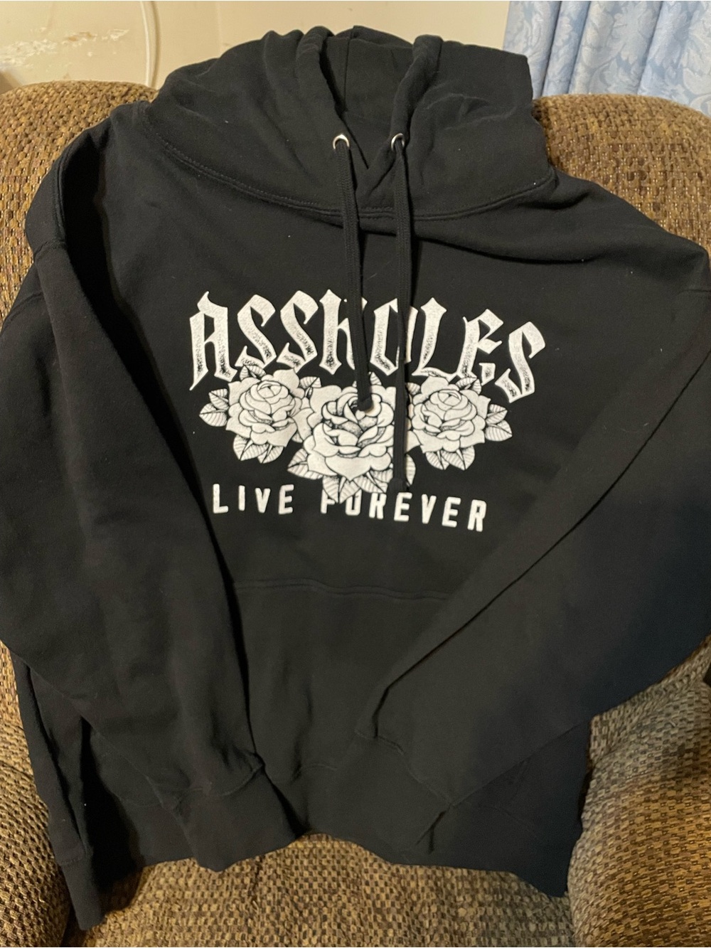 Black Assholes Live Forever Graphic Pullover Hoodie with White Rose Print